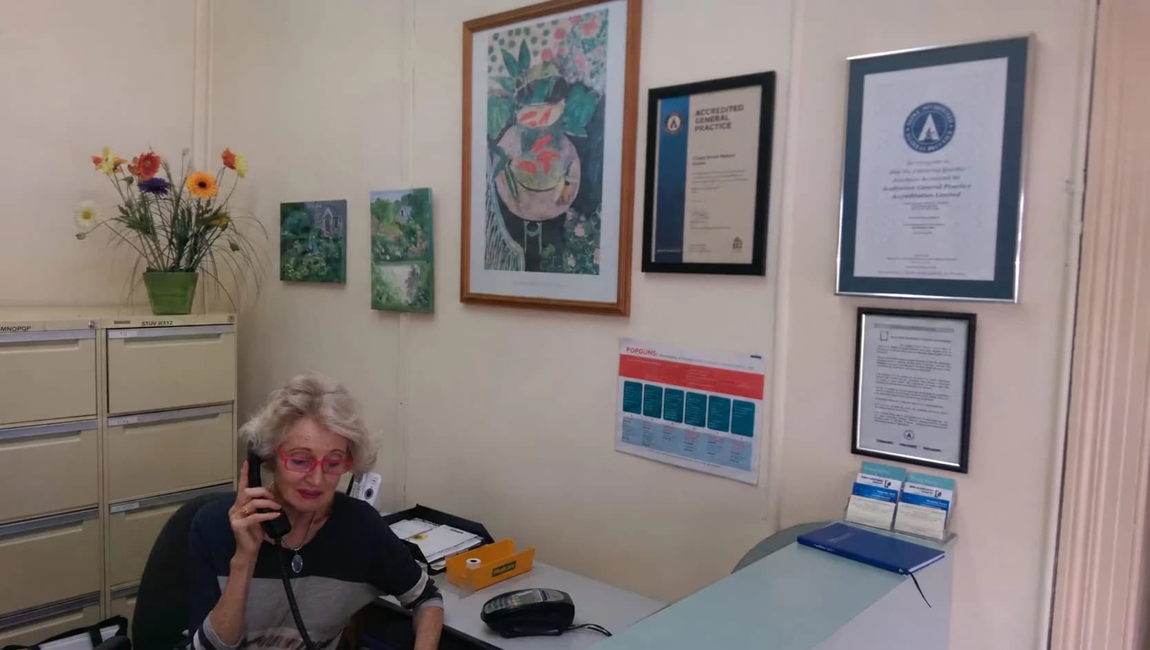 Reception at Chapel Street Medical Centre in St Kilda, with a staff member taking a call